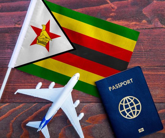 Flag,Of,Zimbabwe,With,Passport,And,Toy,Airplane,On,Wooden Flag,Of,Zimbabwe,With,Passport,And,Toy,Airplane,On,Wooden